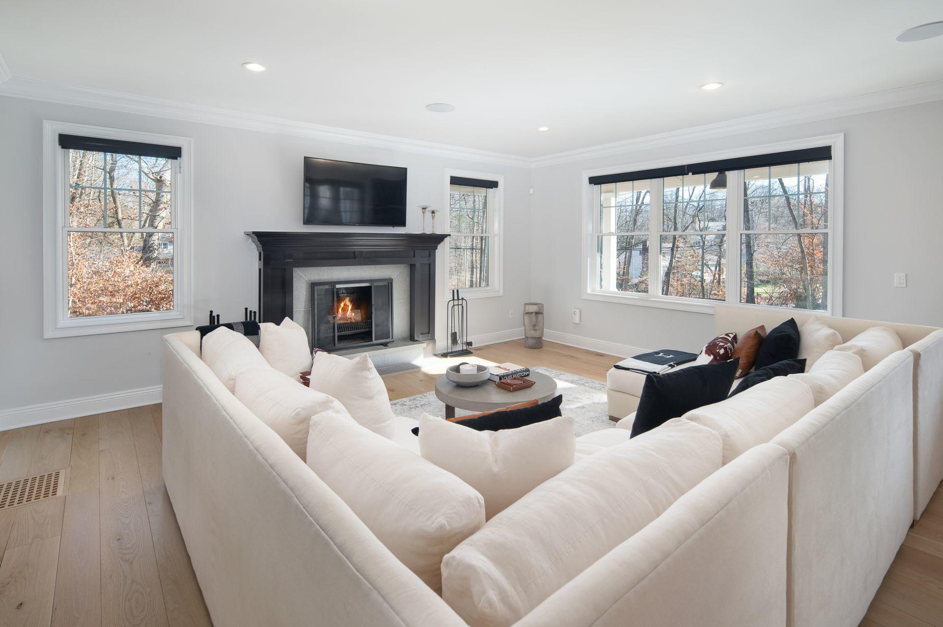 716 Cheese Spring Road New Canaan, CT 06840 - Photo 17 of 56 a living room with furniture large window and fireplace