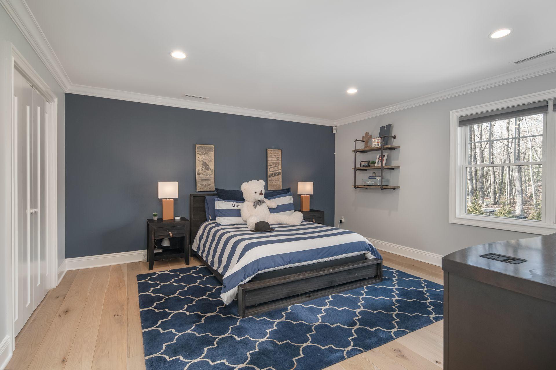 716 Cheese Spring Road New Canaan, CT 06840 - Photo 32 of 56 a bedroom with a bed and wooden floor