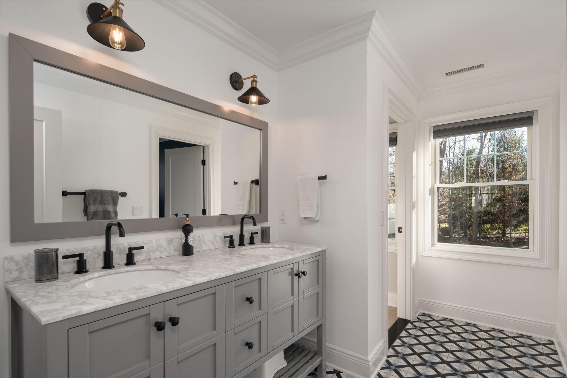 716 Cheese Spring Road New Canaan, CT 06840 - Photo 33 of 56 a spacious bathroom with a granite countertop sink mirror and window