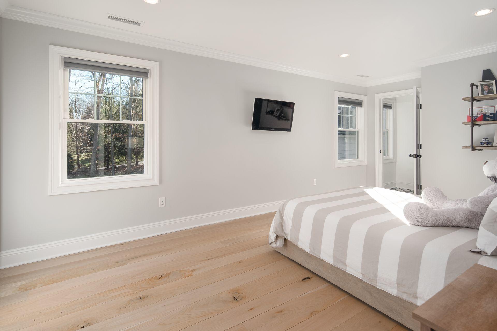 716 Cheese Spring Road New Canaan, CT 06840 - Photo 34 of 56 a bedroom with a bed and a window