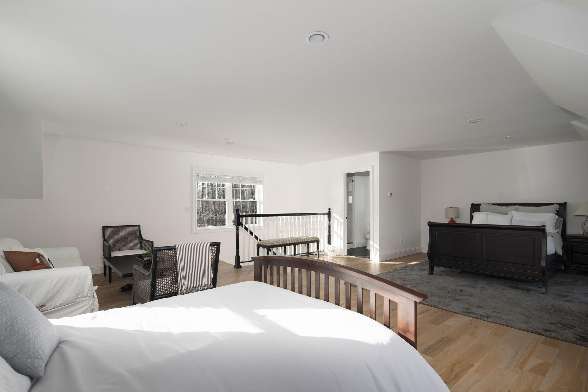 716 Cheese Spring Road New Canaan, CT 06840 - Photo 46 of 56 a bedroom with a bed and a table in it