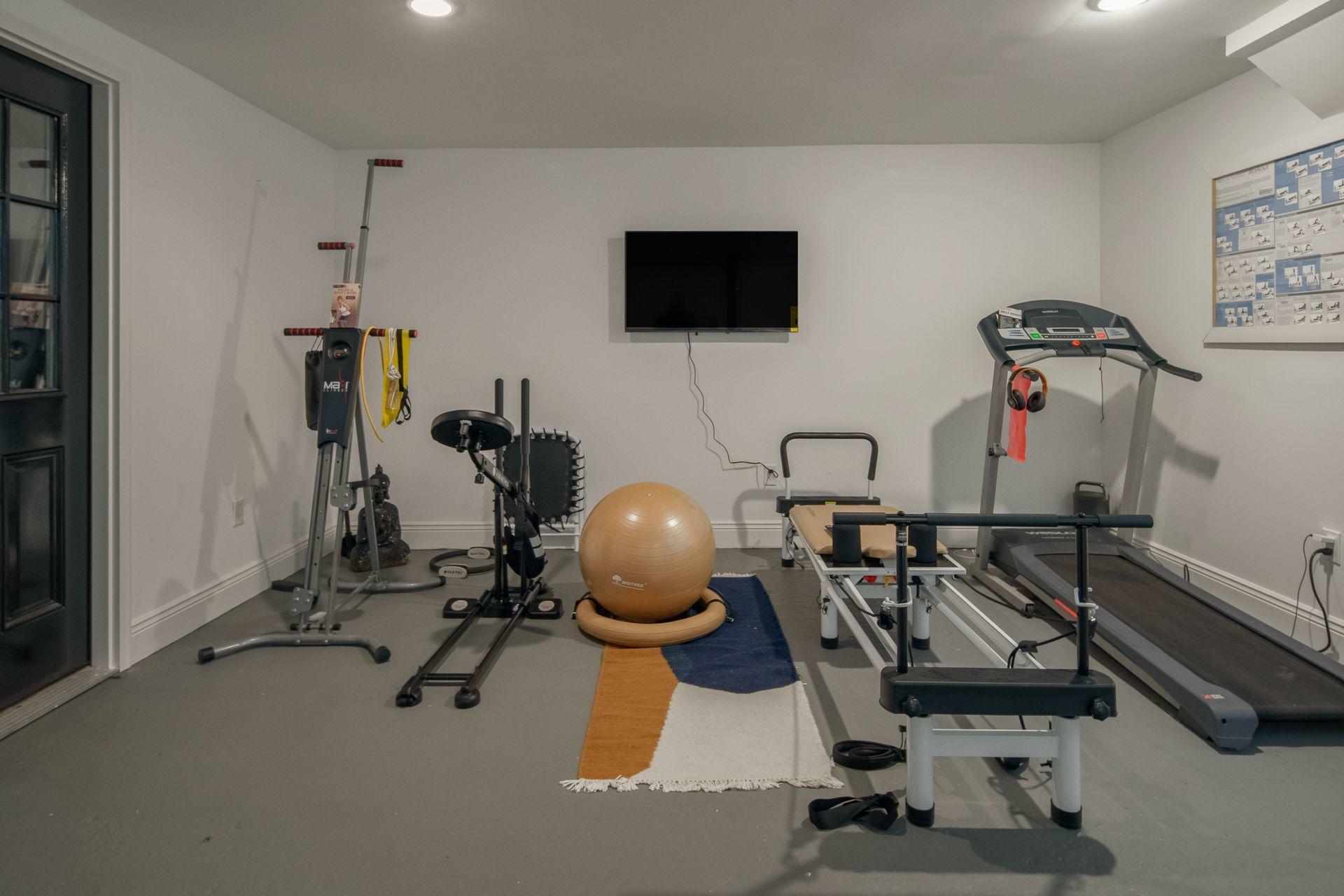 716 Cheese Spring Road New Canaan, CT 06840 - Photo 47 of 56 a view of a room with gym equipment
