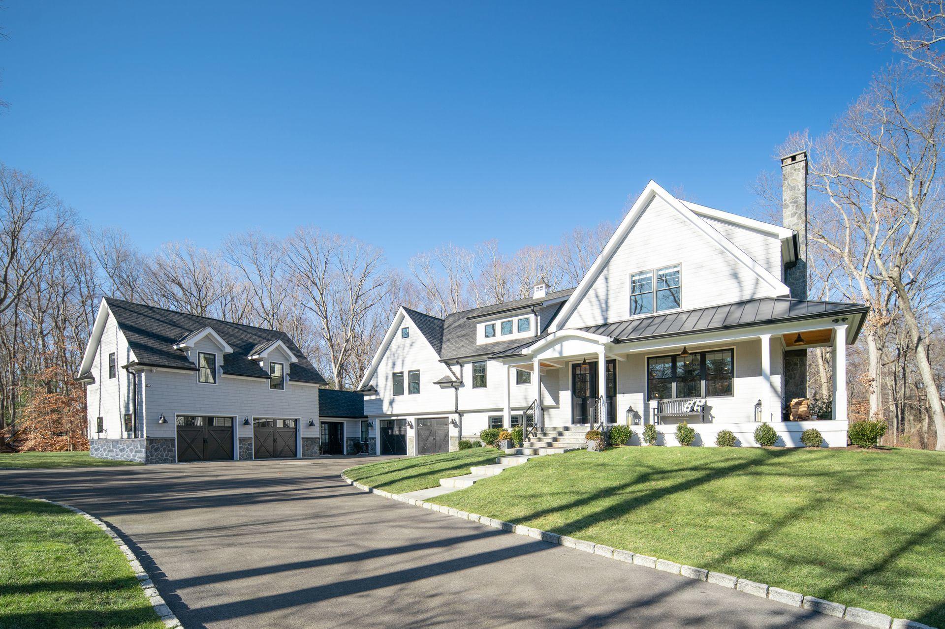 716 Cheese Spring Road New Canaan, CT 06840 - Photo 53 of 56 a front view of a house with a yard