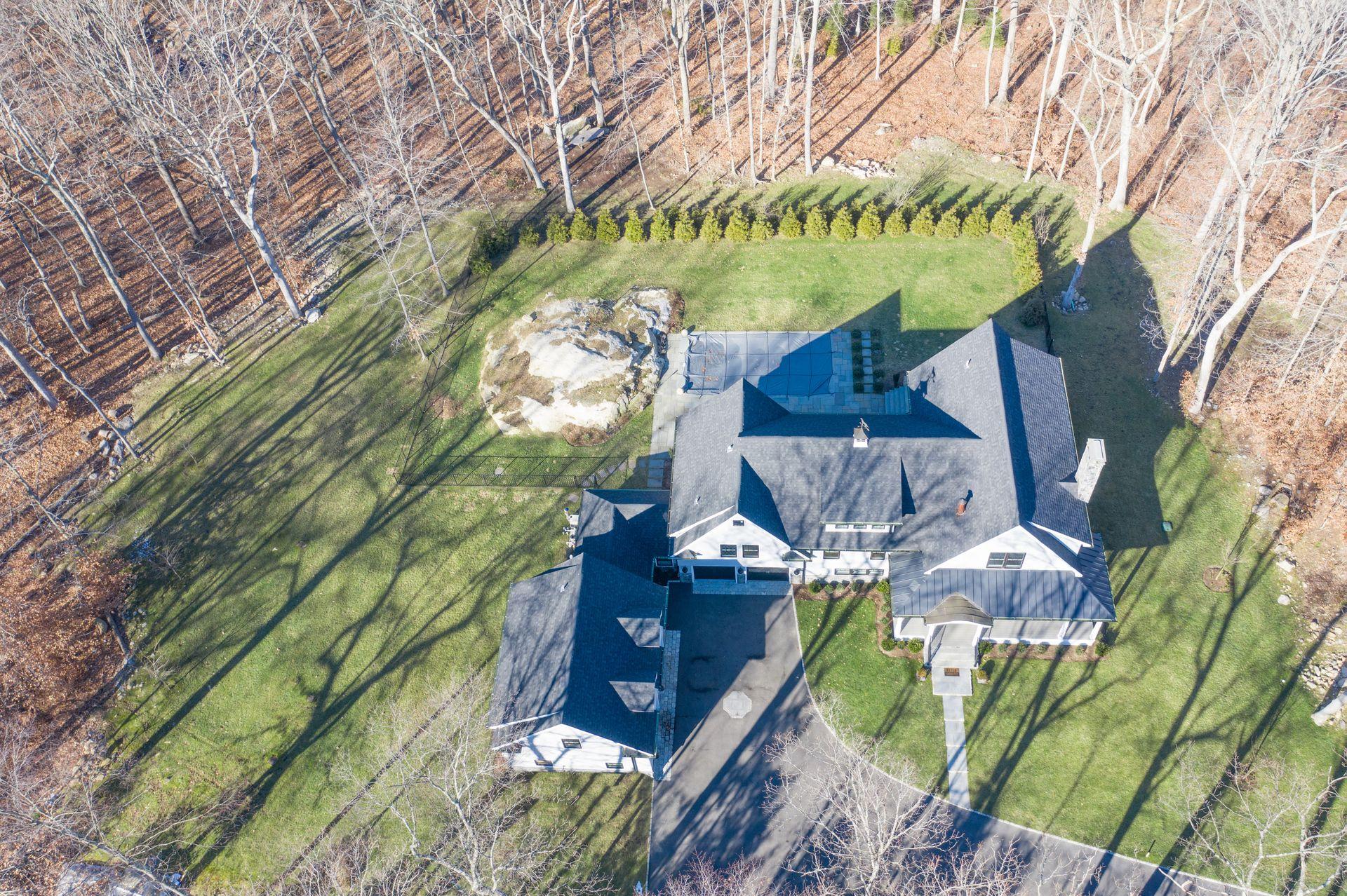 716 Cheese Spring Road New Canaan, CT 06840 - Photo 54 of 56 a view of a house with a yard