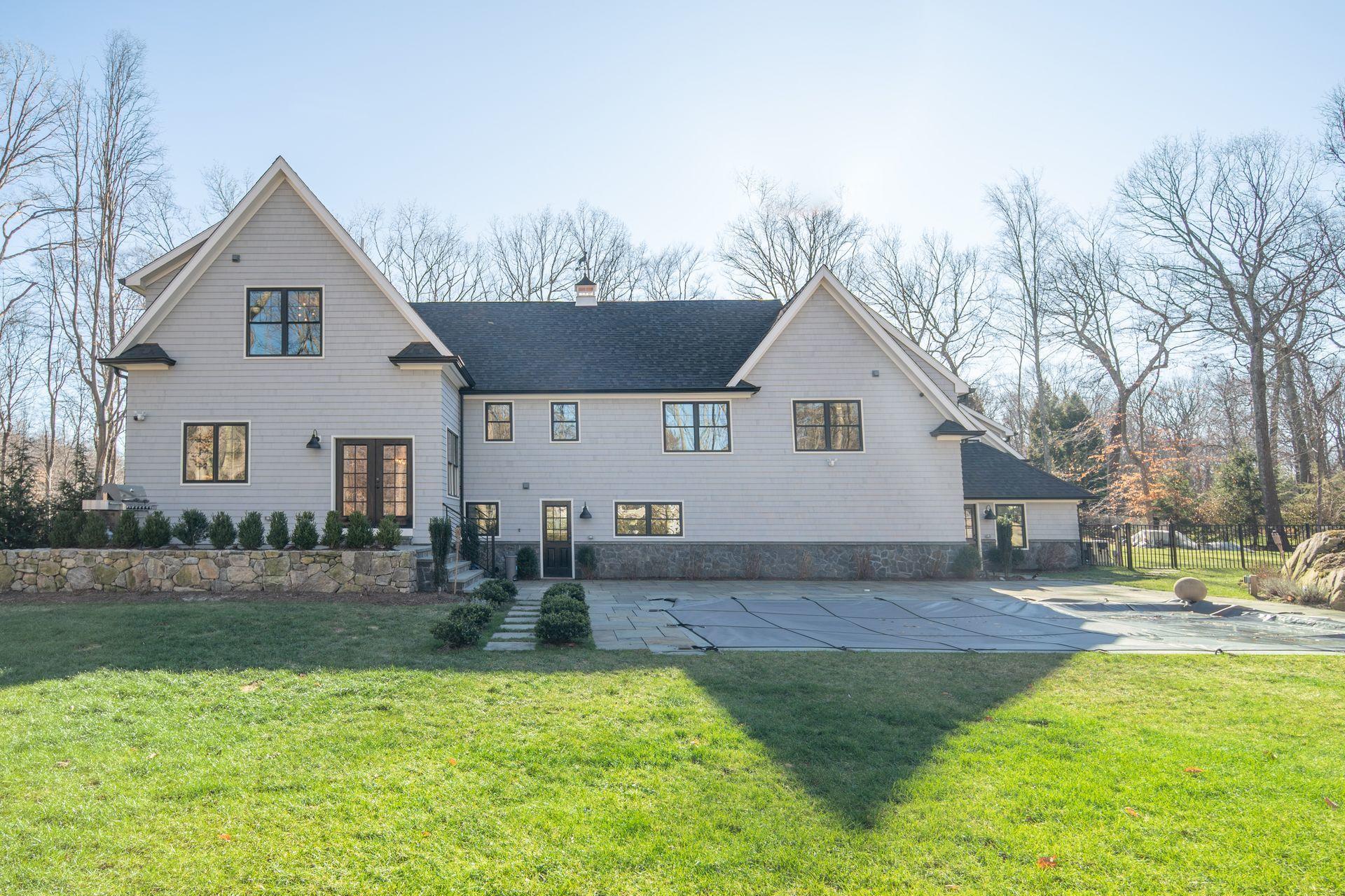 716 Cheese Spring Road New Canaan, CT 06840 - Photo 56 of 56 a front view of a house with garden