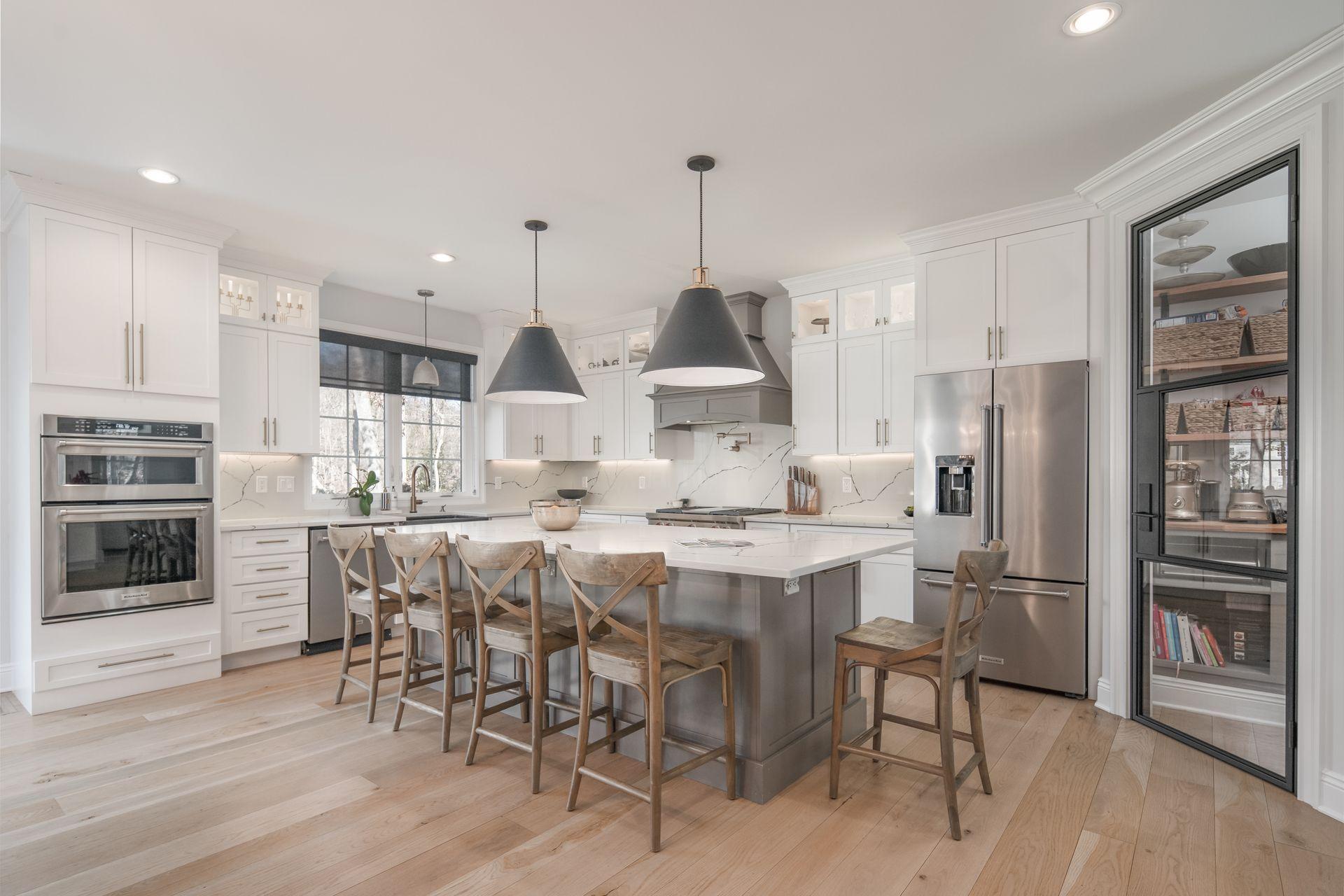 716 Cheese Spring Road New Canaan, CT 06840 - Photo 7 of 56 a kitchen with stainless steel appliances a dining table chairs stove and refrigerator