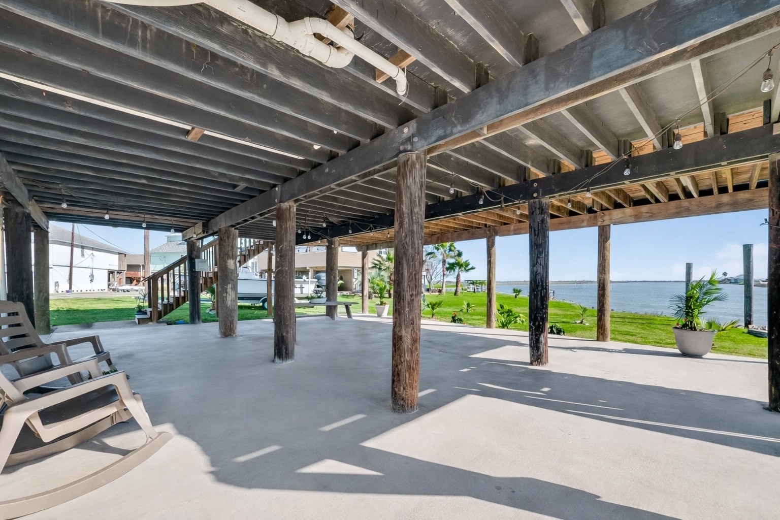 154 Poop Deck Lane Freeport, TX 77541 - Photo 23 of 32 First Floor covered Patio with 1/2 bath and outdoor shower overlooking water