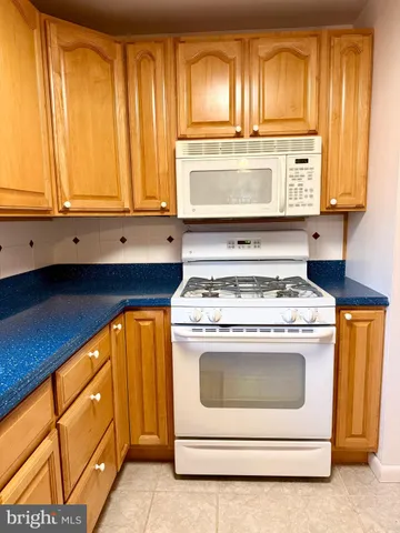 a stove top oven sitting inside of a kitchen