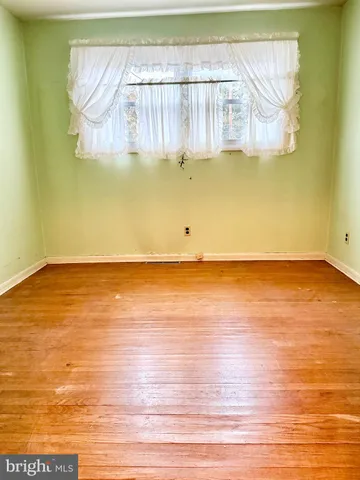 a view of a room with wooden floor and small space