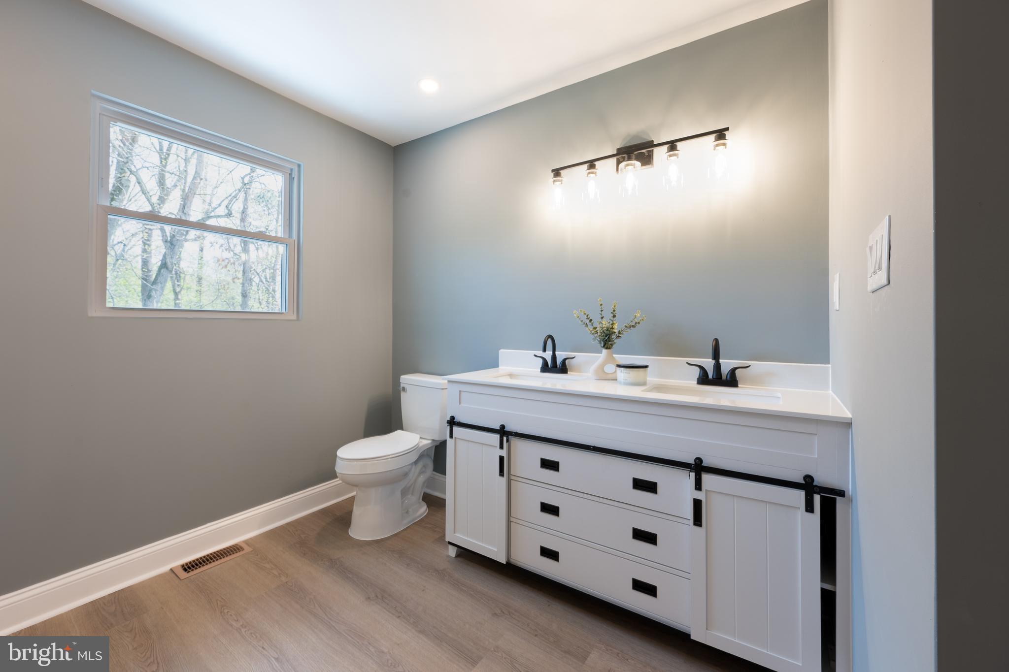3 Slalom Court Pine Hill, NJ 08021 - Photo 26 of 47 a bathroom with a double vanity sink a toilet and a window
