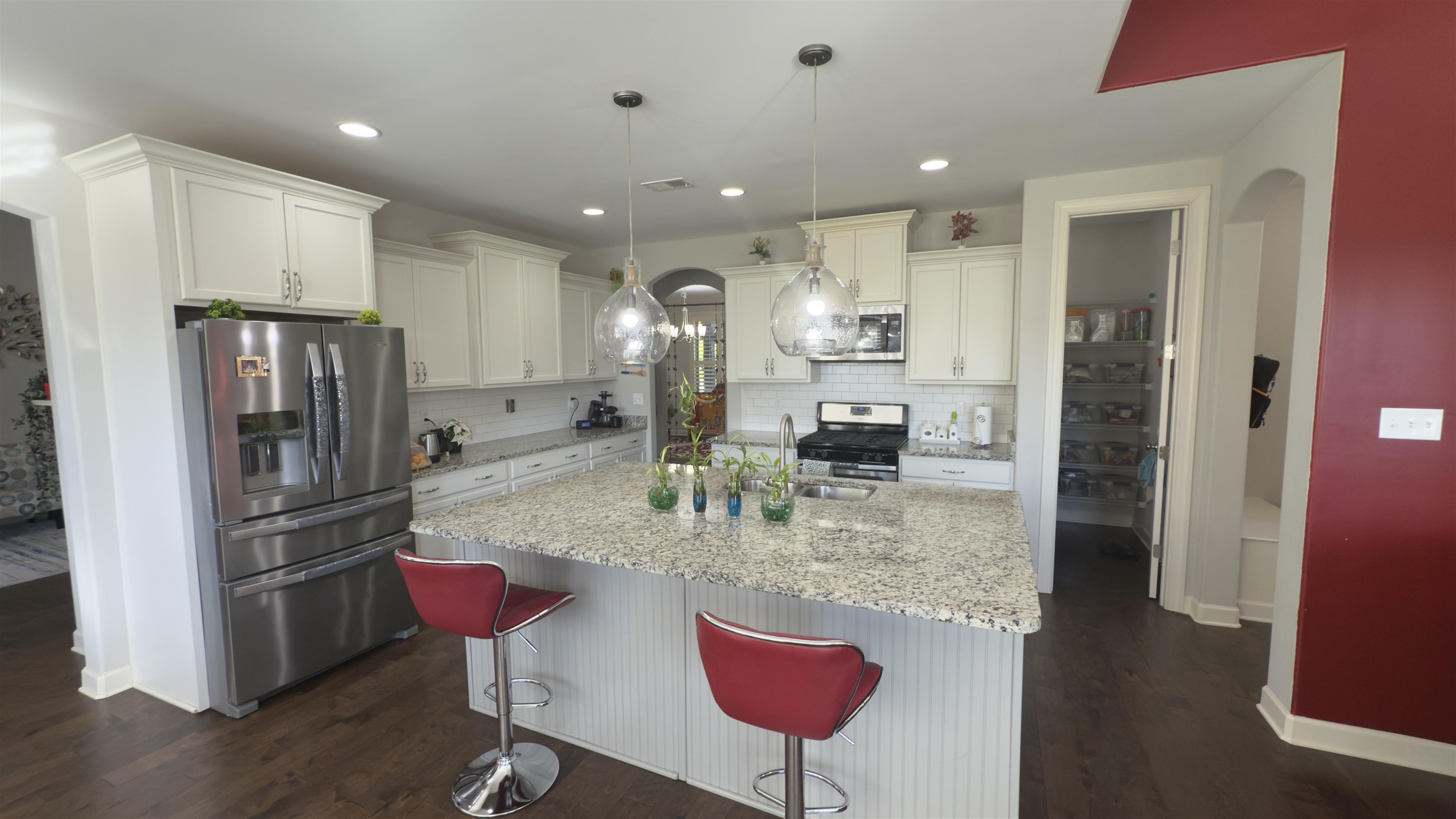 1217 Pilgrim Ridge Road Collierville, TN 38017 - Photo 9 of 33 Kitchen featuring appliances with stainless steel finishes, an island with sink, pendant lighting, dark wood-style flooring, and recessed lighting