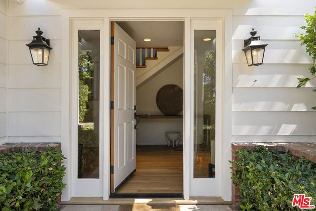 a view of entryway and hall with wooden floor