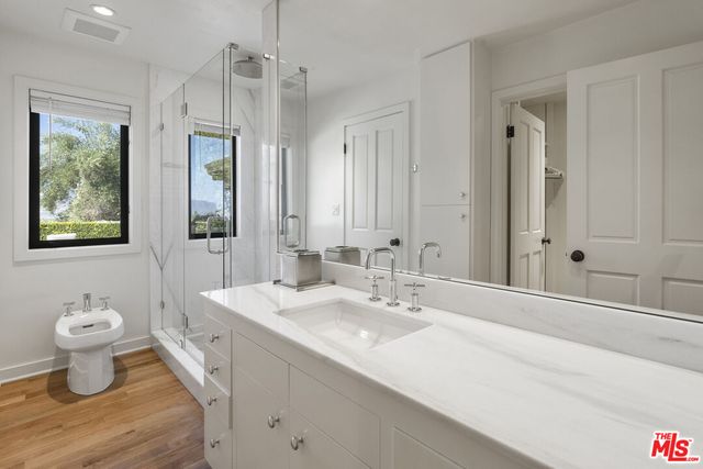 a bedroom with a bed next to a large window