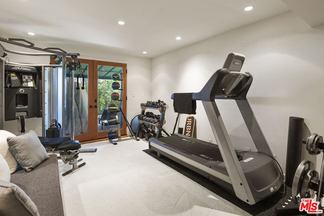 a bedroom with a bed a flat screen tv and a couch