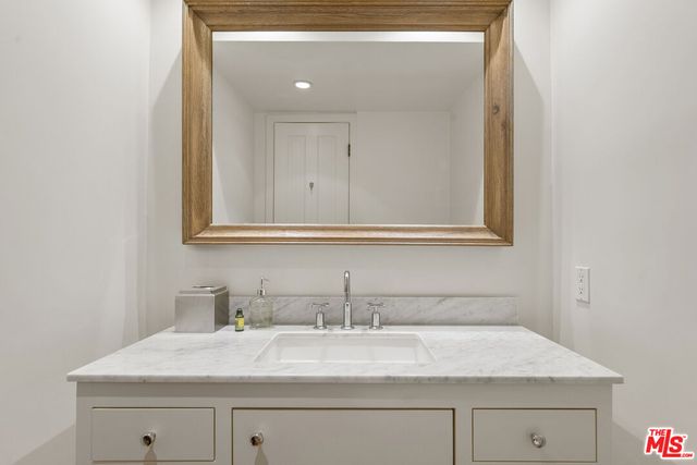 a spacious bedroom with a bed and wooden floor