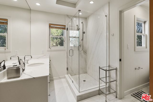 a bathroom with a double vanity sink mirror and double