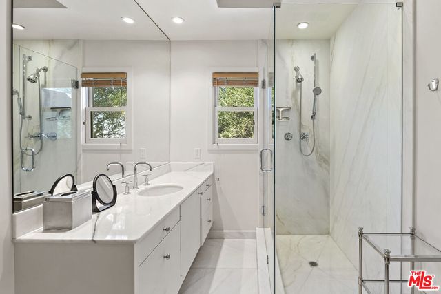 a spacious bedroom with a large bed and a large window