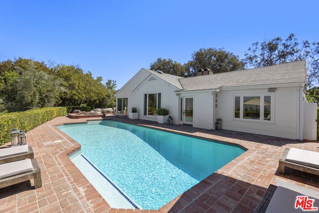 a view of a swimming pool with a yard