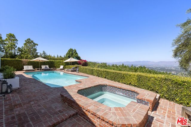 a view of a backyard with sitting area