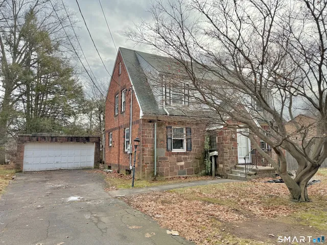 a view of a house with a yard and garage