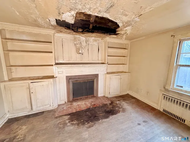 a view of a livingroom with an empty space and wooden floor