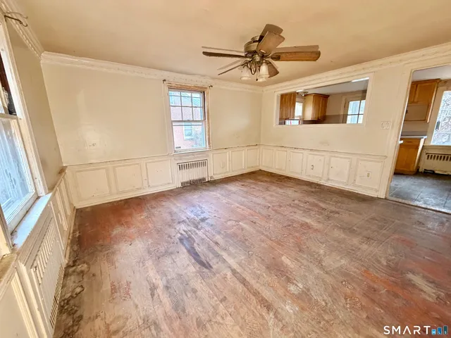 a view of a livingroom with a hardwood floor and a ceiling fan