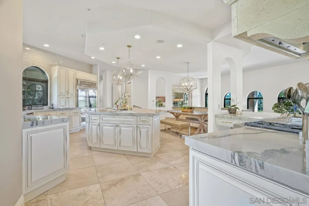 5305 La Crescenta Road Rancho Santa Fe, CA 92067 - Photo 10 of 64 Gorgeous remodeled kitchen with new cabinetry, exotic quartzite counter tops, top of the line appliances and fixtures, and designer lighting.Paint virtually enhanced to match FR