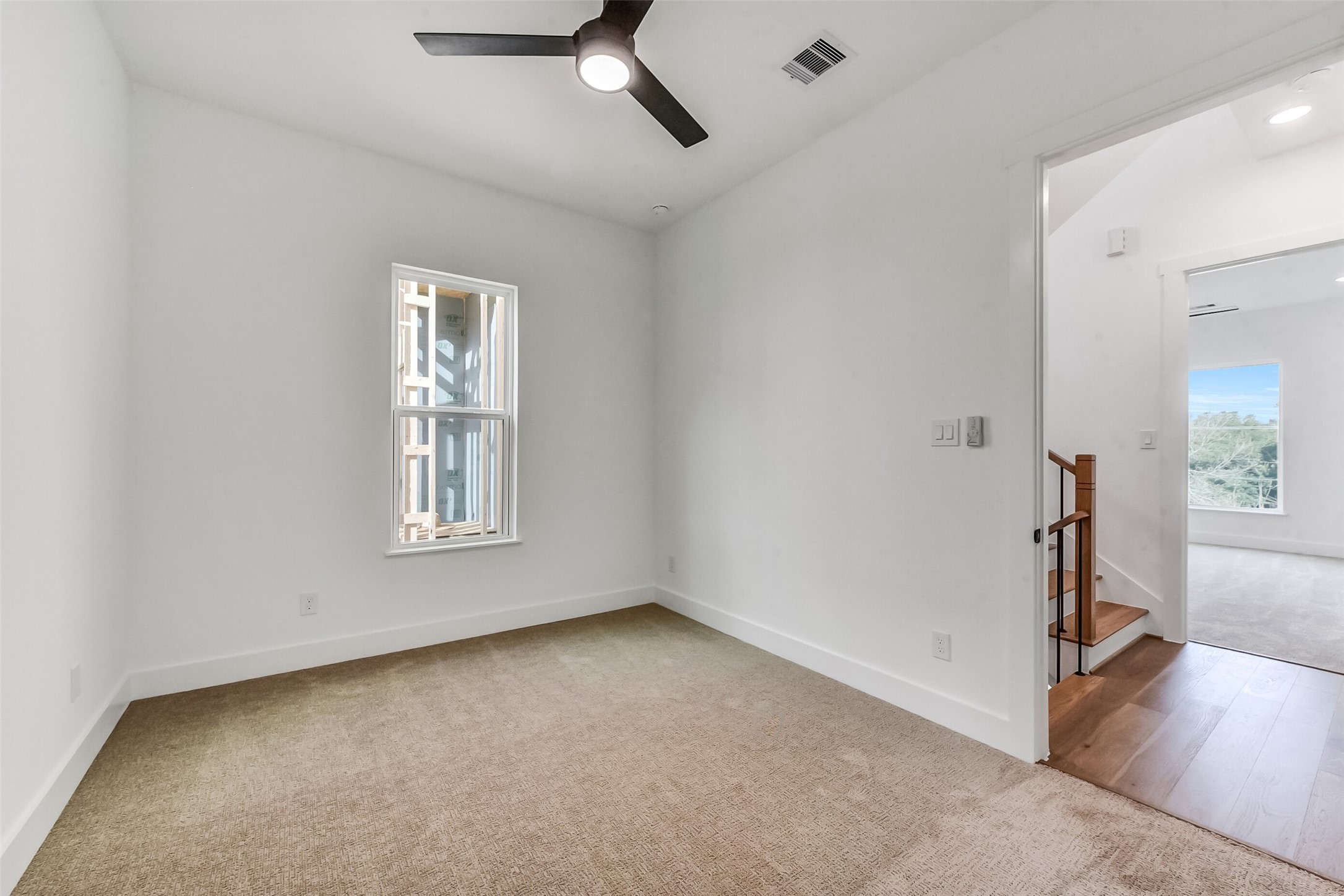 806 Fisher Street, Unit B Houston, TX 77018 - Photo 17 of 27 wooden floor in an empty room with a window