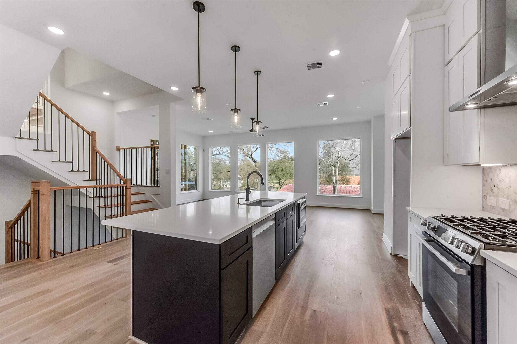 806 Fisher Street, Unit B Houston, TX 77018 - Photo 2 of 27 a kitchen with counter top space appliances wooden floor and a view of living room