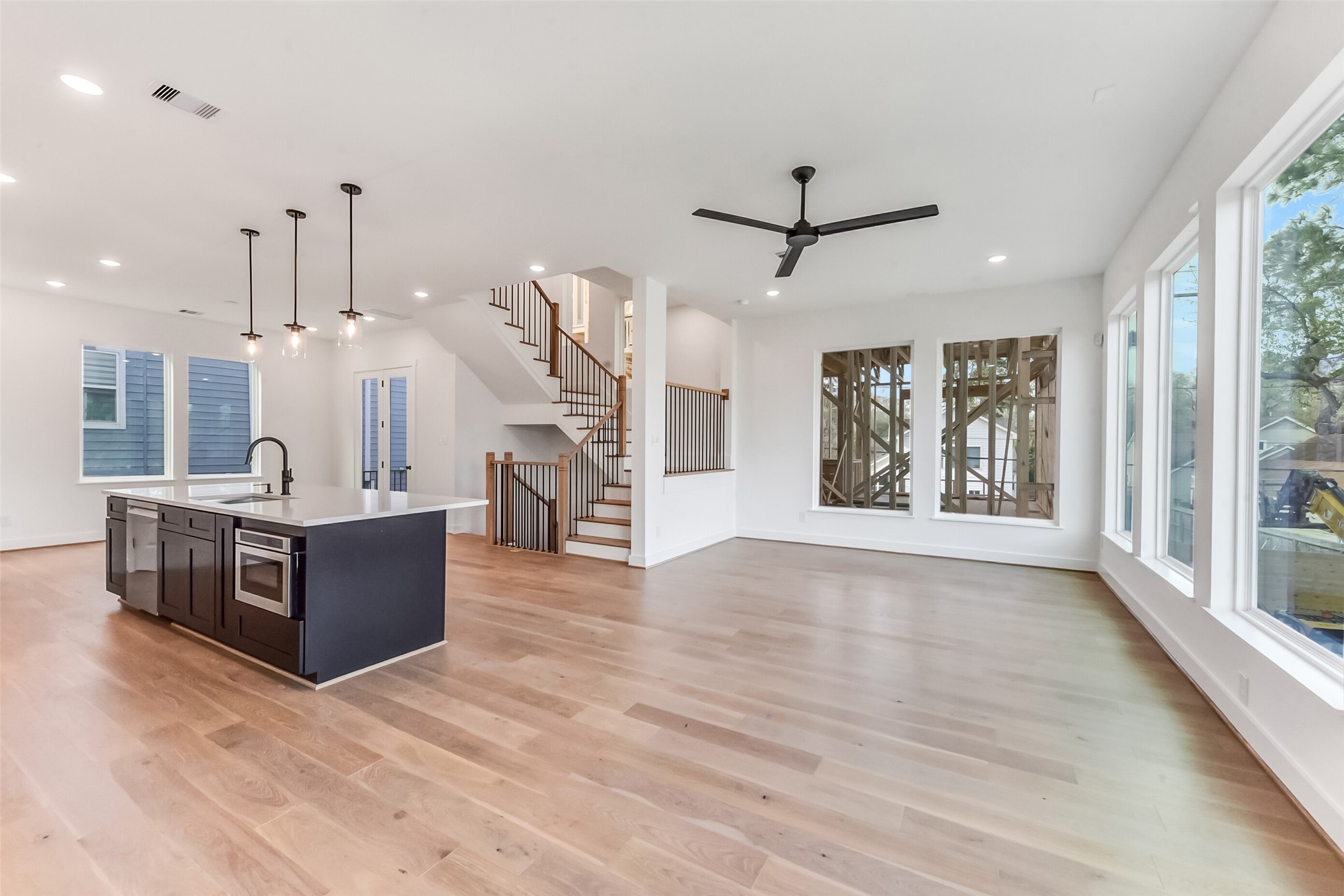 806 Fisher Street, Unit B Houston, TX 77018 - Photo 4 of 27 a large room with kitchen island wooden floor and a chandelier