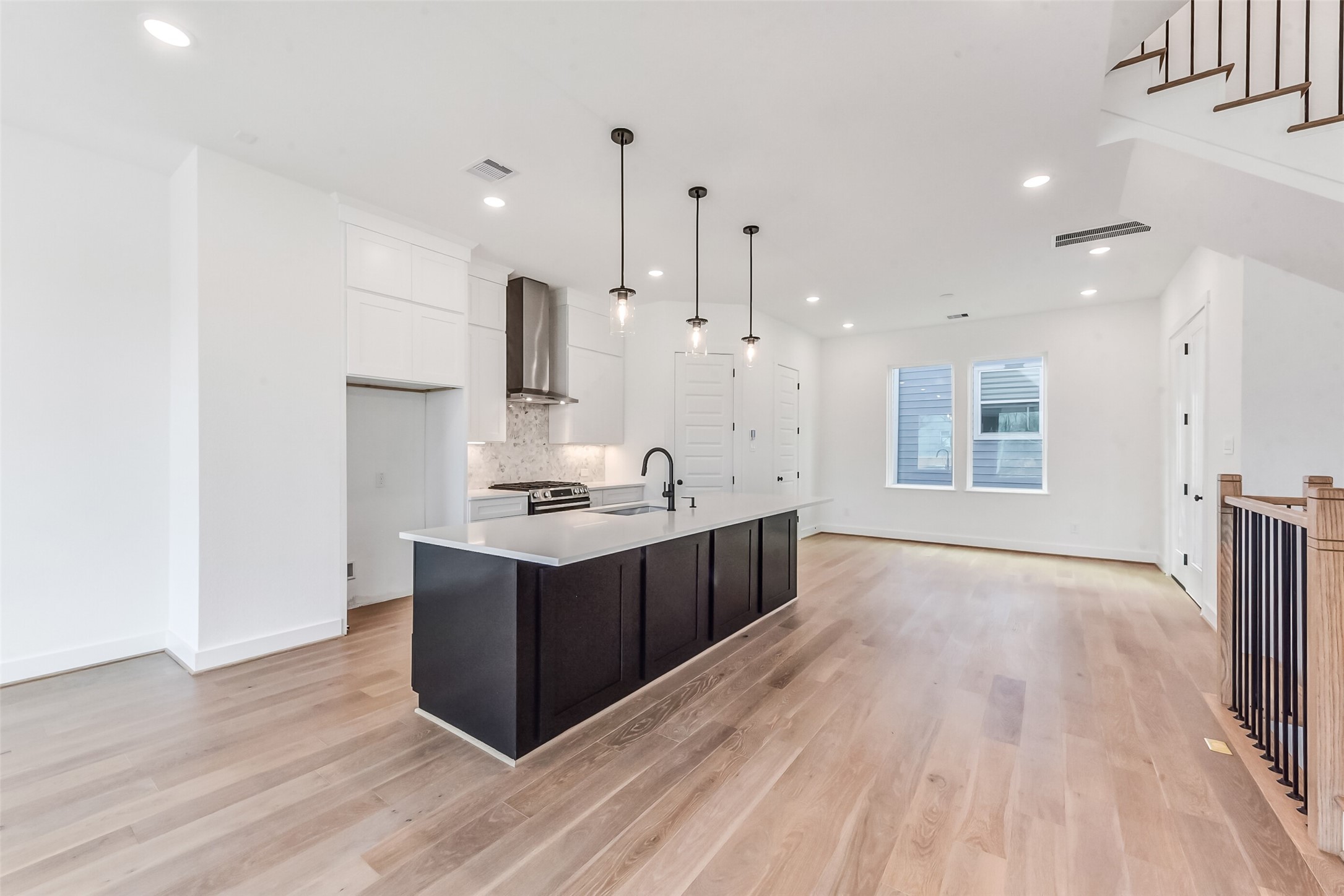 806 Fisher Street, Unit B Houston, TX 77018 - Photo 6 of 27 a large room with kitchen island a sink dishwasher a stove and wooden floor