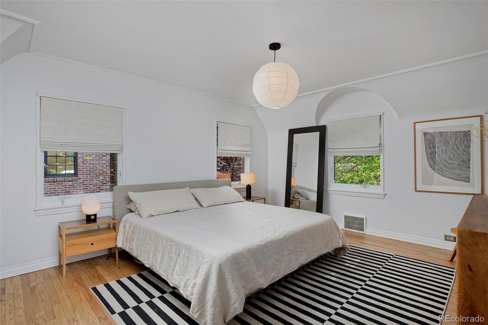 590 Race Street Denver, CO 80206 - Photo 26 of 50 a bedroom with a bed and a chandelier