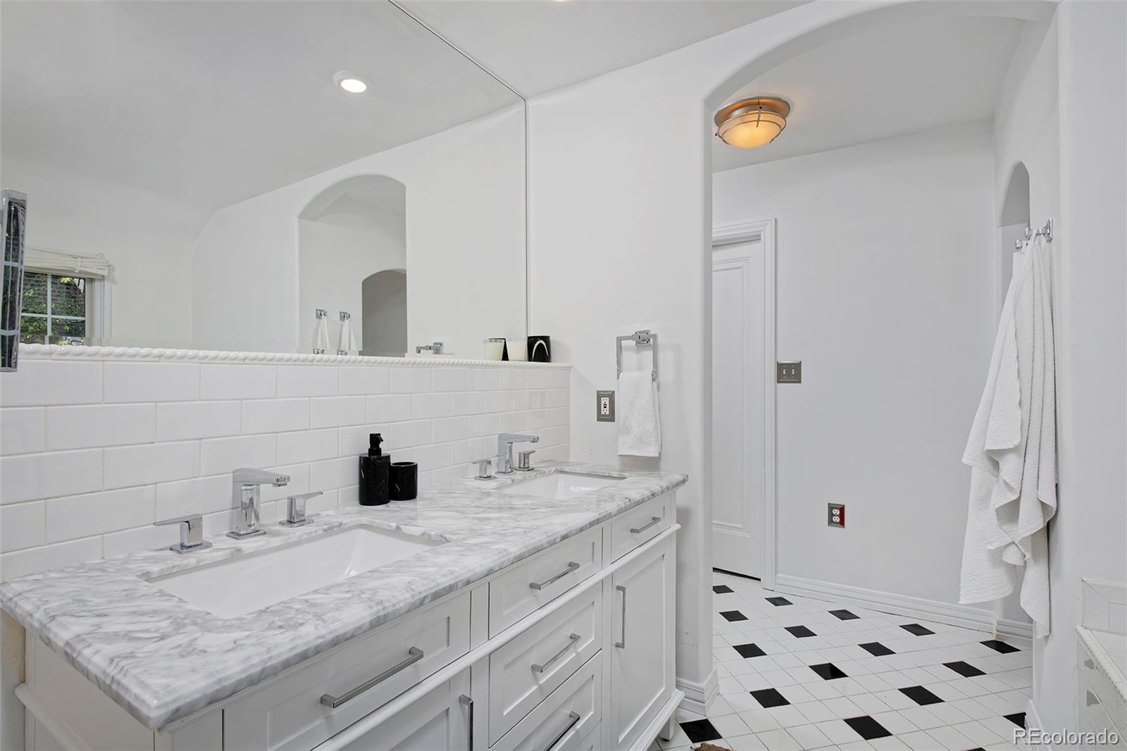 590 Race Street Denver, CO 80206 - Photo 28 of 50 a bathroom with a granite countertop sink a mirror and shower