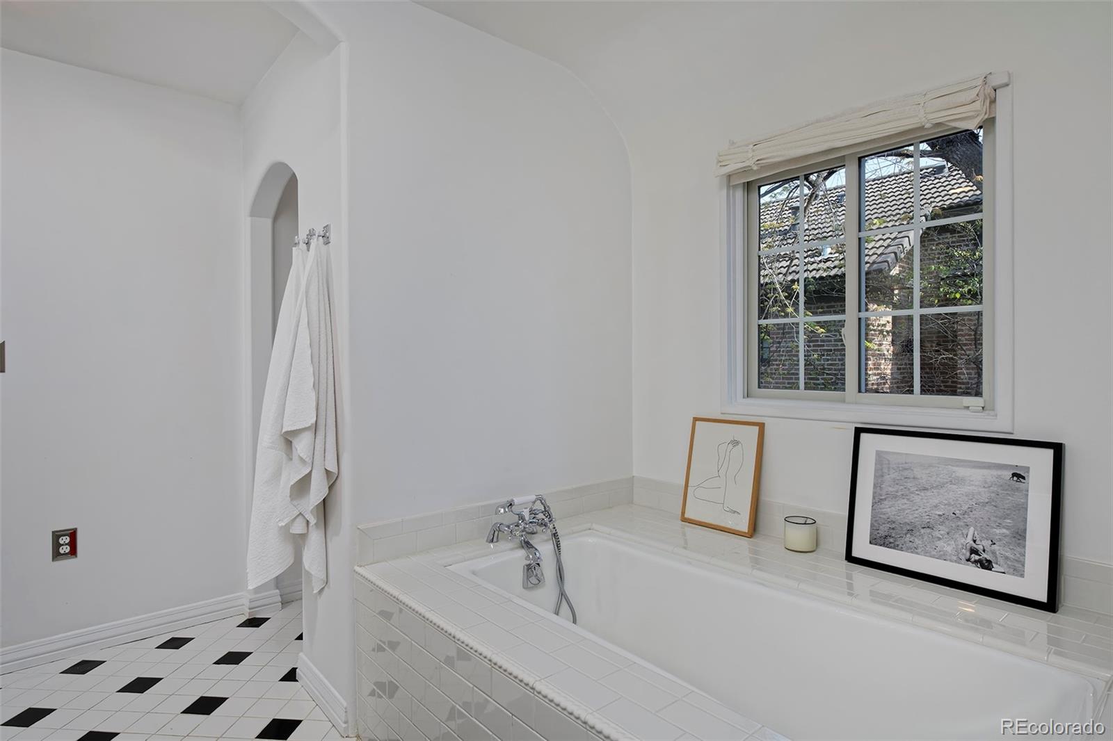 590 Race Street Denver, CO 80206 - Photo 29 of 50 a bathroom with a bathtub and a window