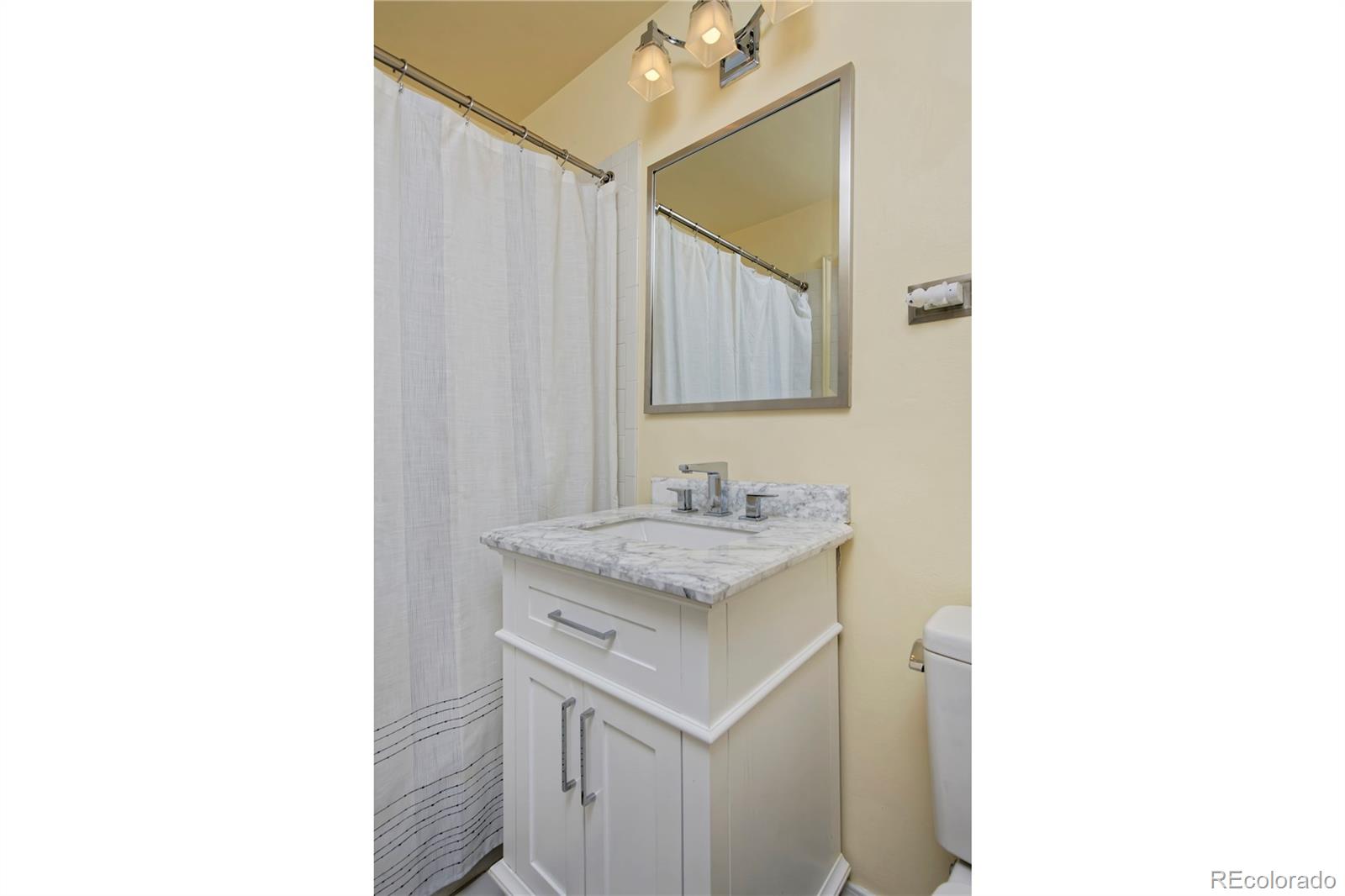 590 Race Street Denver, CO 80206 - Photo 33 of 50 a bathroom with a sink and a mirror