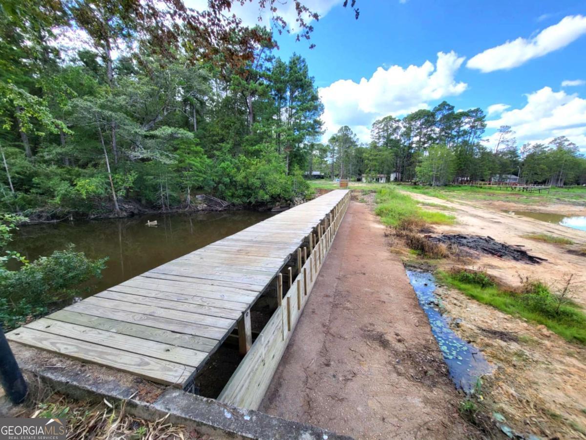 188 Brenda Road Twin City, GA 30471 - Photo 17 of 48 a view of a wooden floor next to a lake