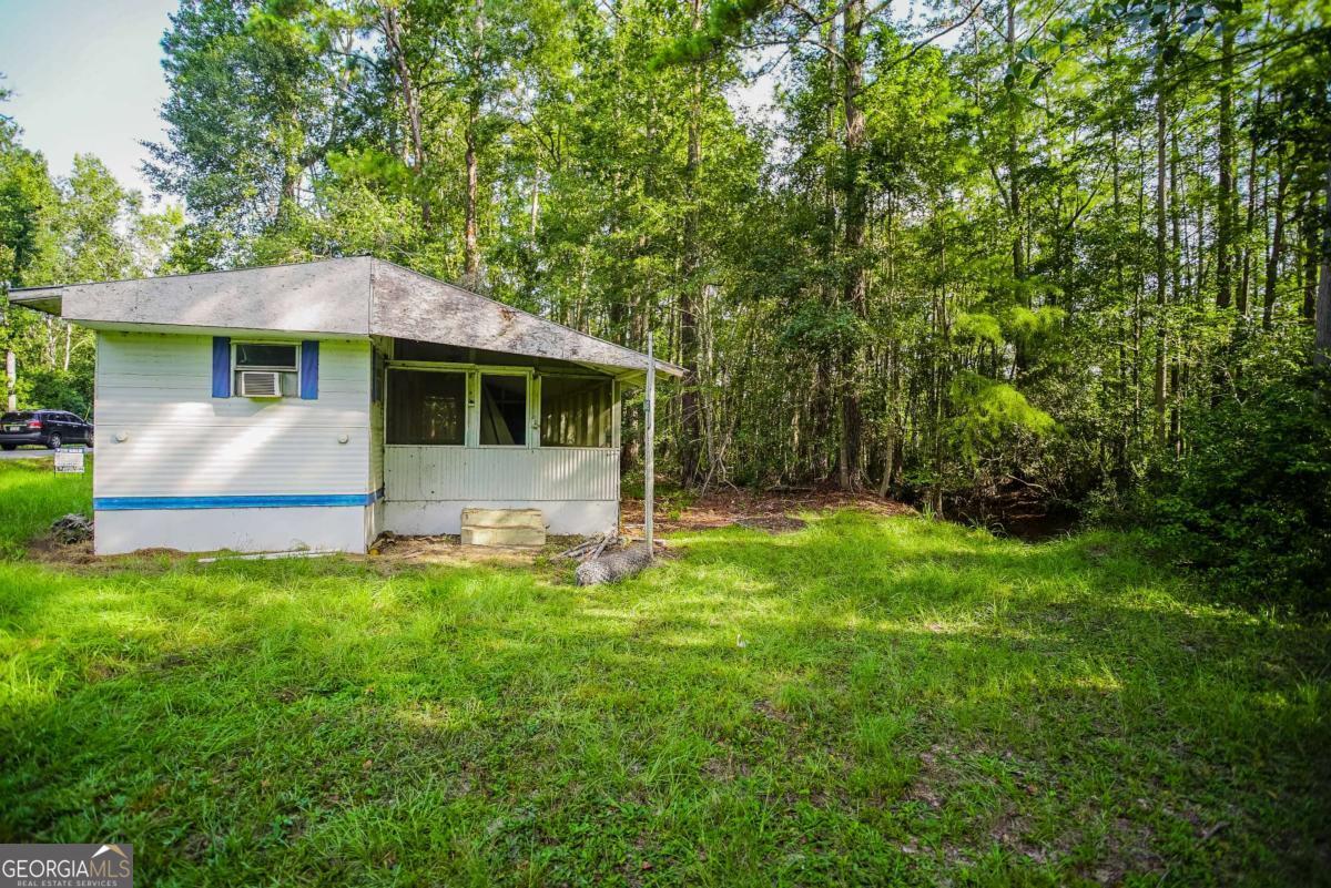 188 Brenda Road Twin City, GA 30471 - Photo 6 of 48 a front view of a house with a yard