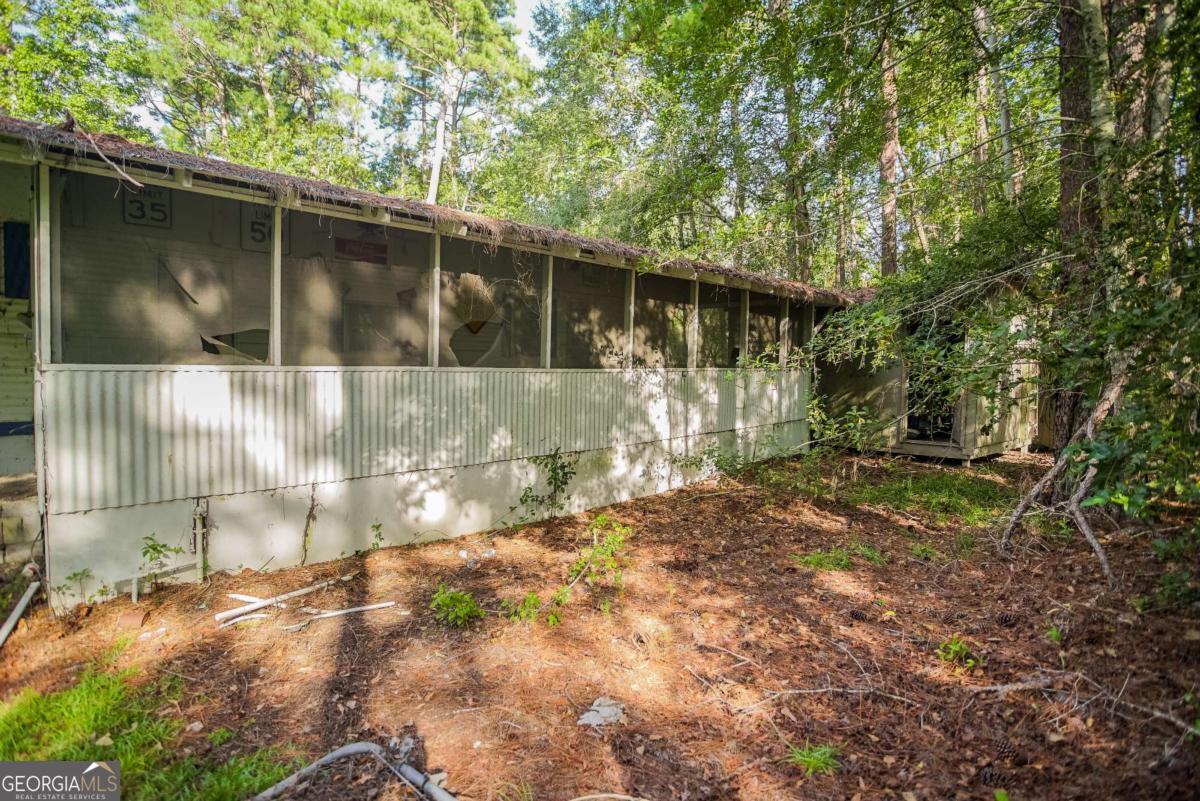 188 Brenda Road Twin City, GA 30471 - Photo 8 of 48 a backyard of a house with lots of green space