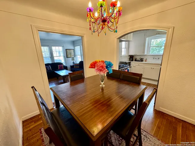 a view of a dining room with furniture and a chandelier