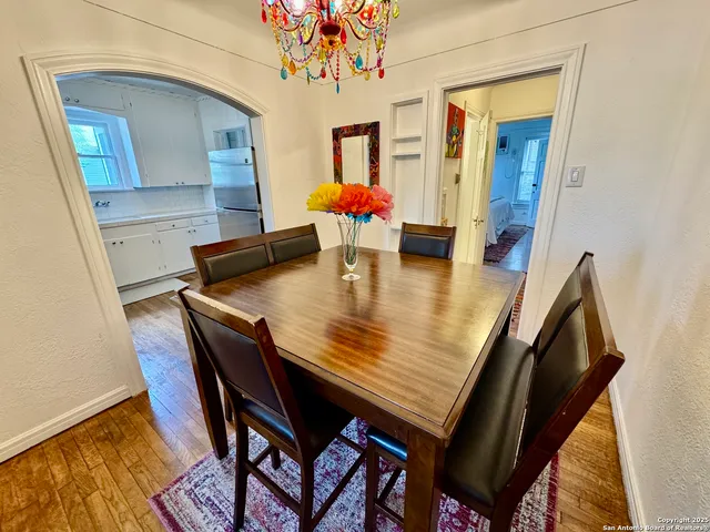 a dining room with furniture and wooden floor