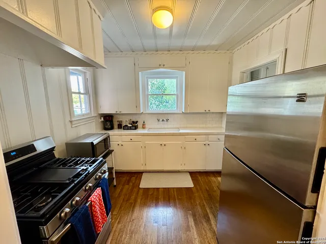 a kitchen with a sink stove and refrigerator