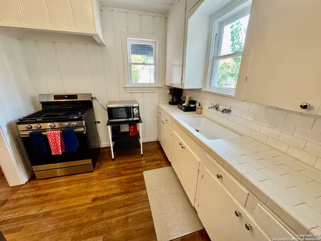a kitchen with stainless steel appliances granite countertop a stove and a sink