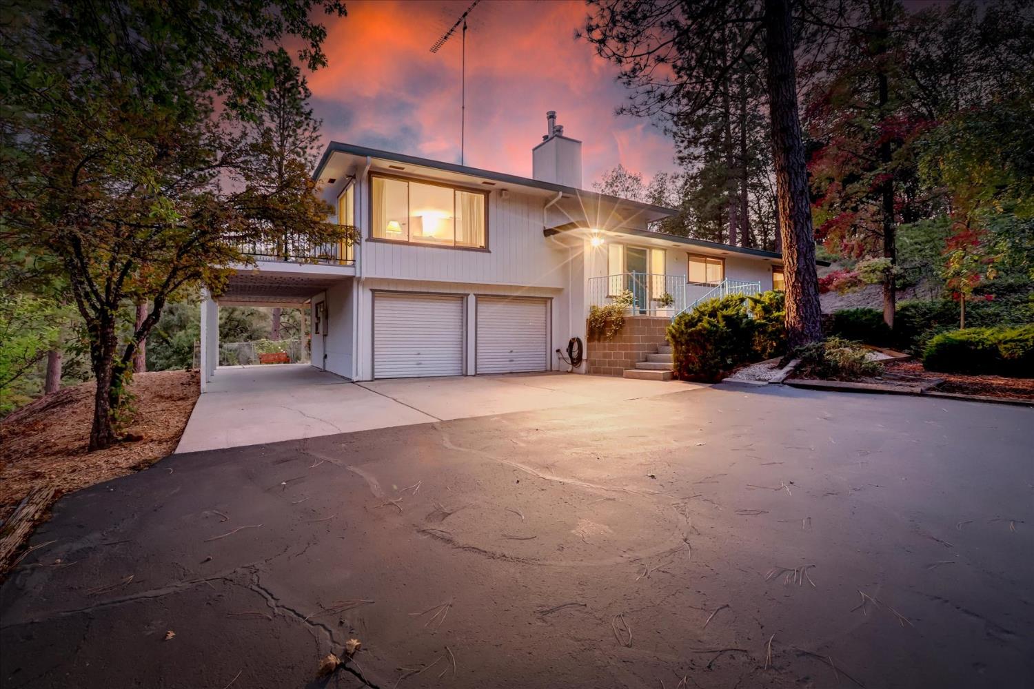 a view of a house with a yard and garage