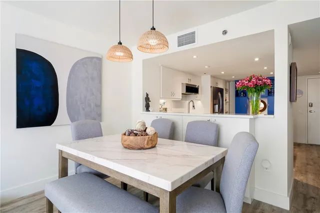 a view of a dining room with furniture and a chandelier