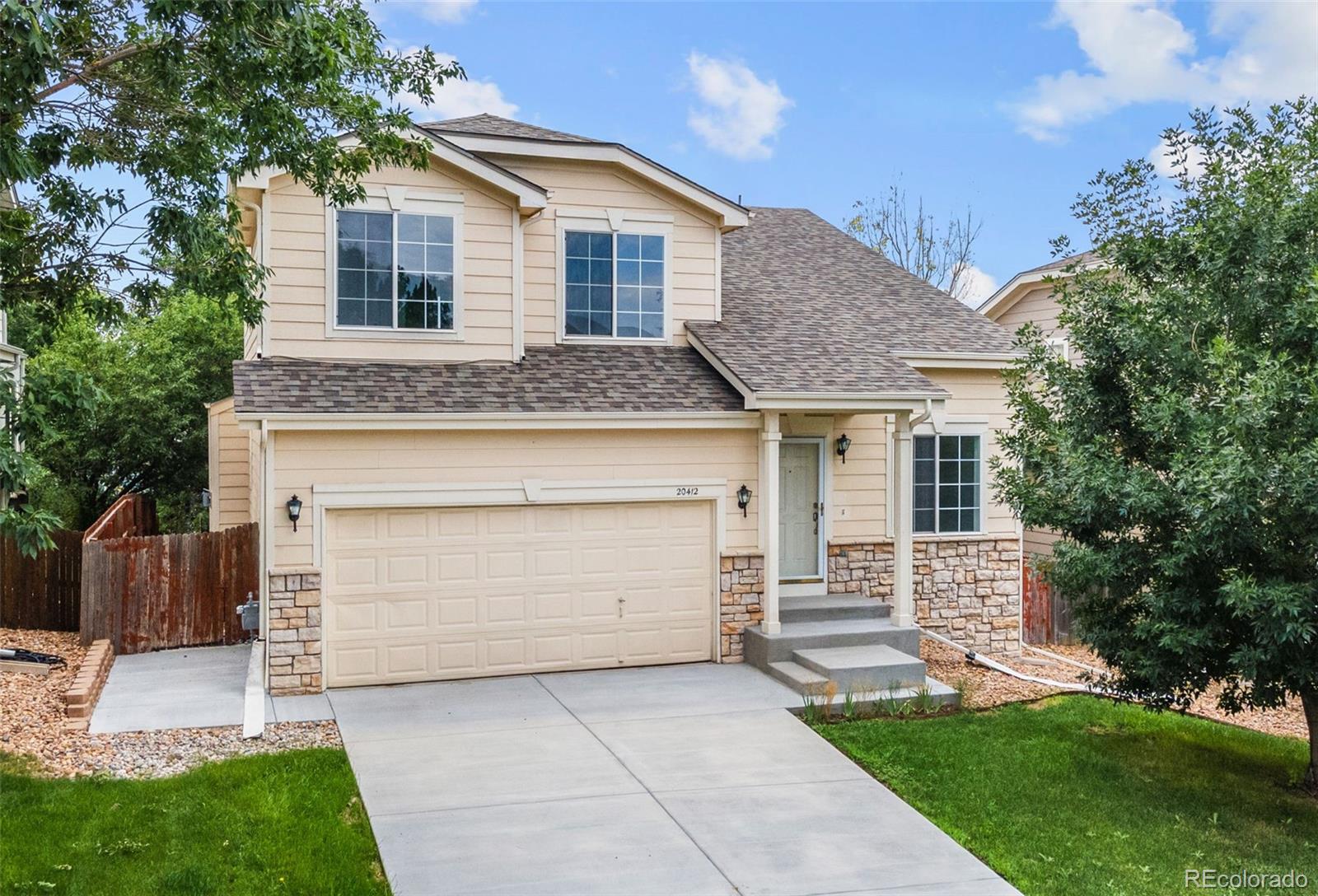 20412 East Chenango Place Aurora, CO 80015 - Photo 1 of 25 a front view of a house with a yard