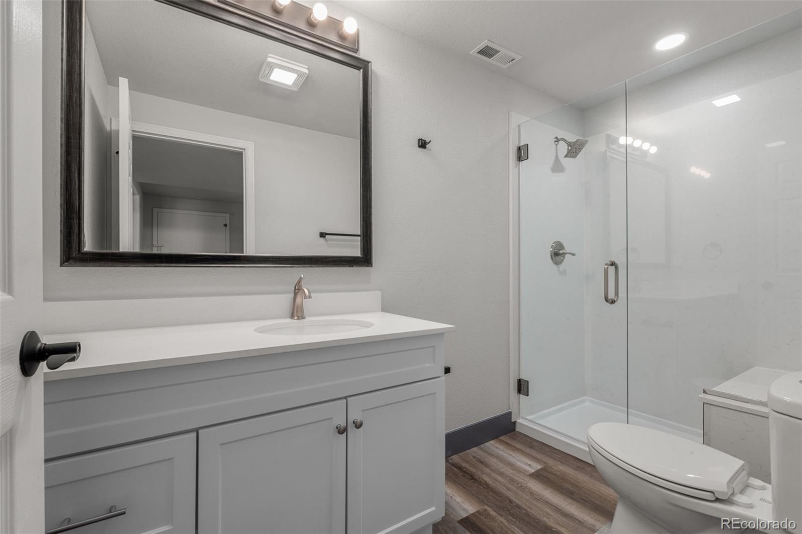 20412 East Chenango Place Aurora, CO 80015 - Photo 12 of 25 a bathroom with a sink a toilet and shower