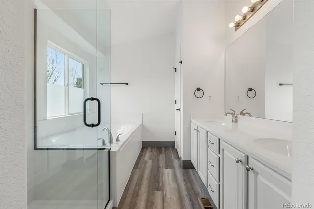 a bathroom with a double vanity sink a toilet and a mirror