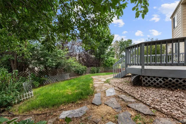 a view of a black and white house with a yard