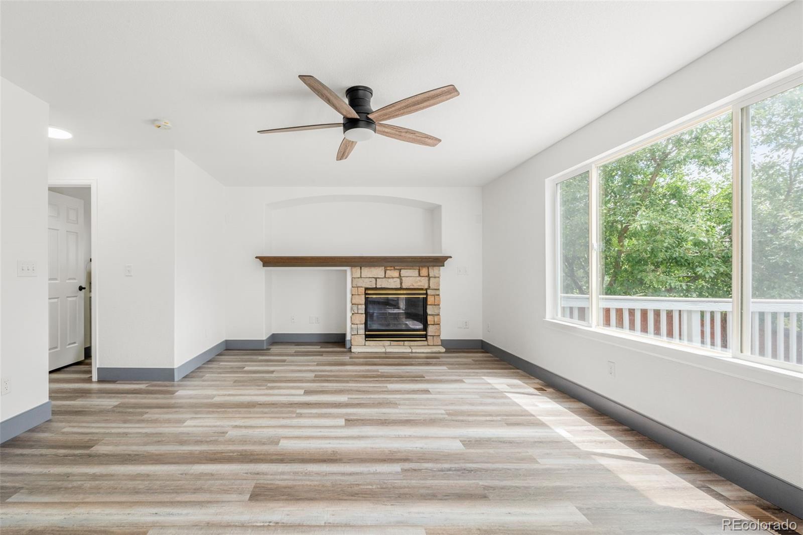 20412 East Chenango Place Aurora, CO 80015 - Photo 5 of 25 a view of an empty room with a window and a kitchen