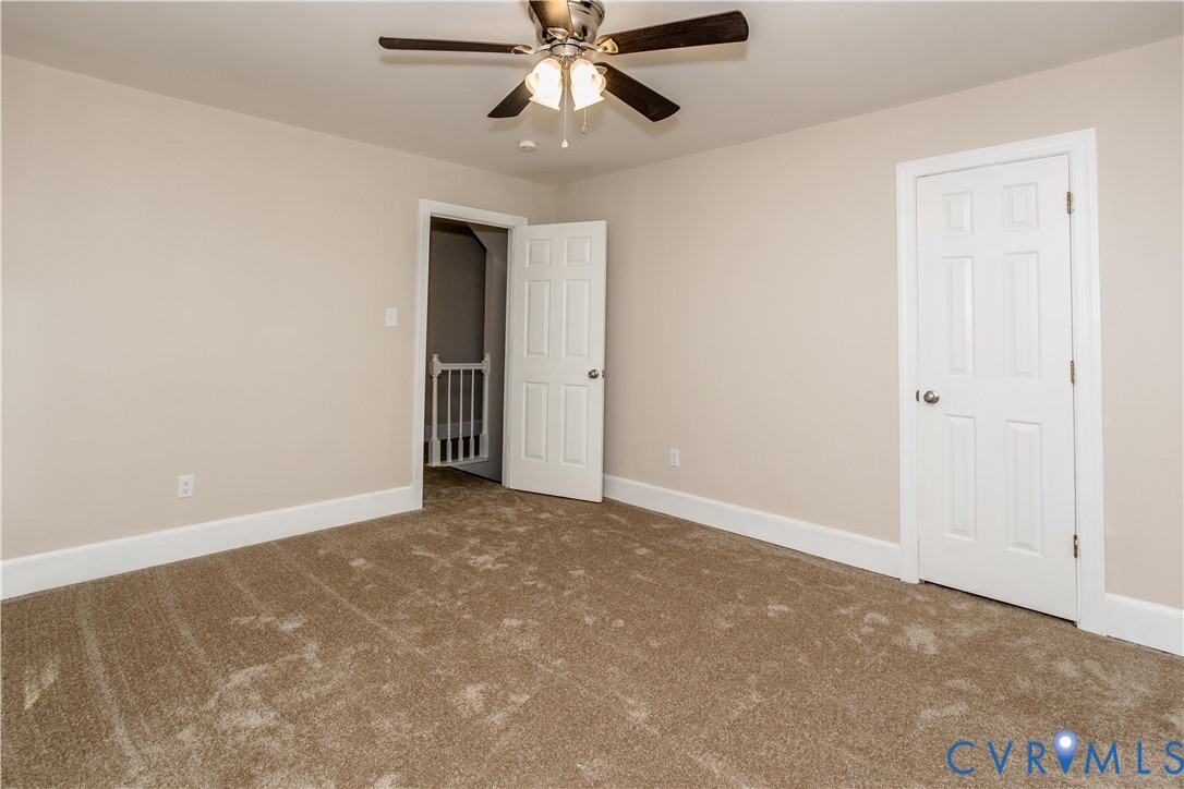13110 Hensley Road Midlothian, VA 23112 - Photo 22 of 24 an empty room with closet and a chandelier fan